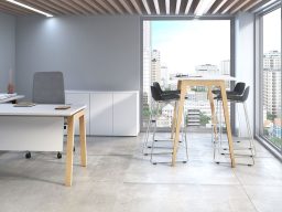Bureau moderne avec mobilier en bois, grandes fenêtres et vue sur la ville.